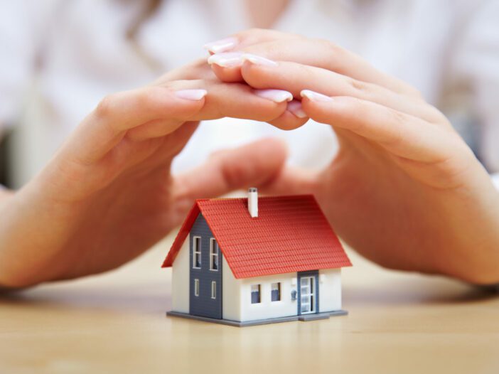 Female,Hands,Saving,Small,House,With,A,Roof